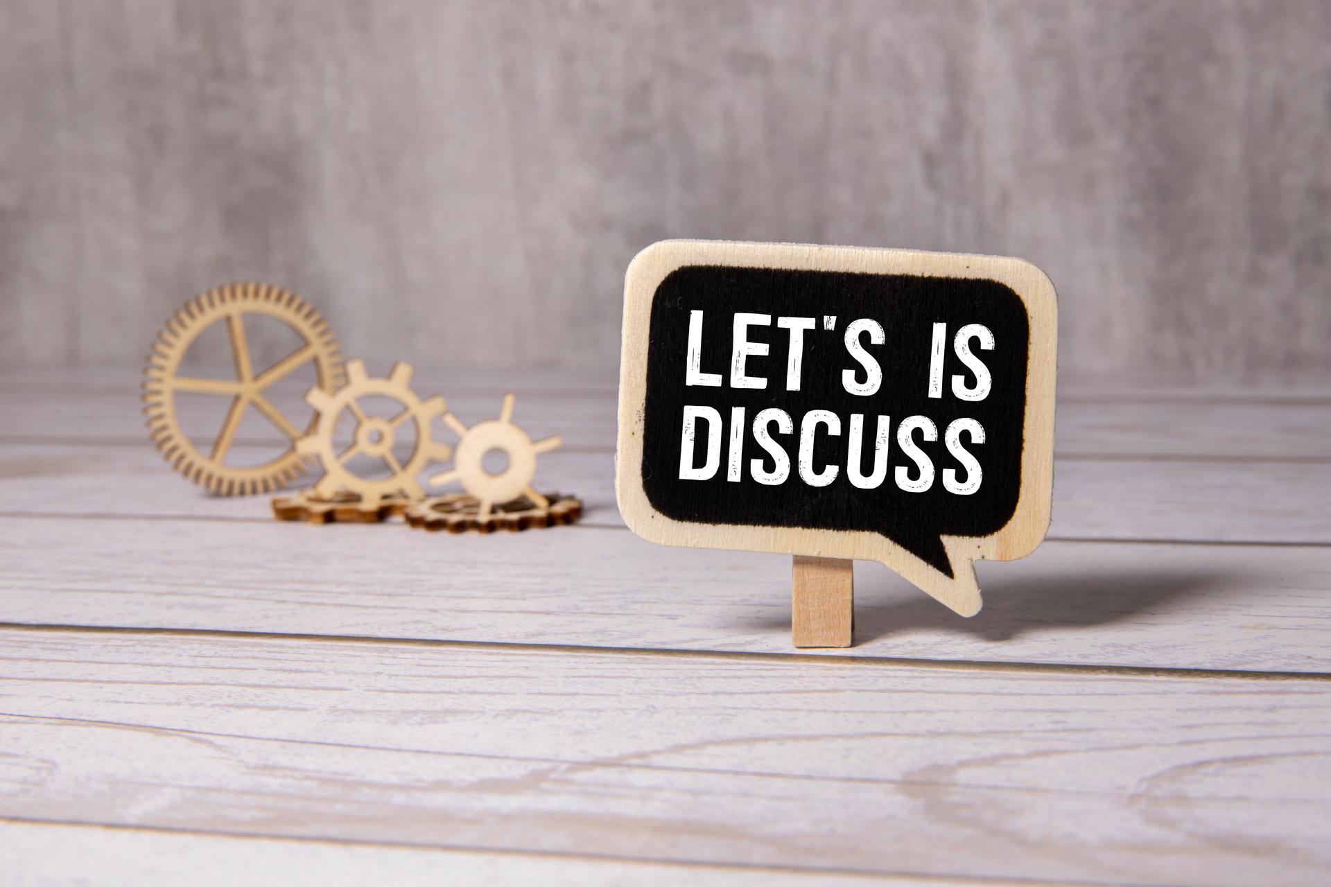 Let s Us Discuss speech bubble isolated on the blue background